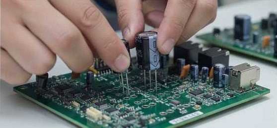 Manual assembly of THT components with leads inserted through PCB holes