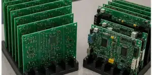 Bare PCB panels compared with assembled PCBA samples on an engineering bench
