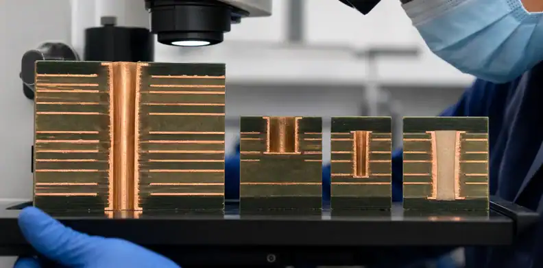 PCB hole and via cross-sections examined under a microscope