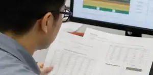 Engineer comparing laminate data and PCB stack-up for material substitution approval