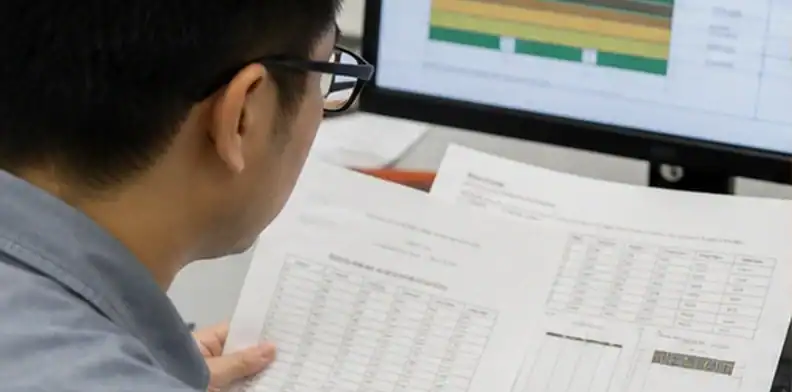 Engineer comparing laminate data and PCB stack-up for material substitution approval