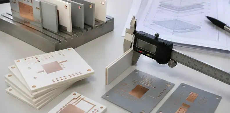 An engineering bench reviews ceramic pcb thickness with ceramic substrate samples and copper measurement notes.