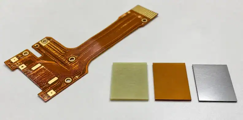 Flex pcb stiffener material choice with FR4 polyimide and steel samples beside a flex circuit