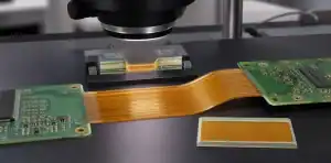 A microscope inspects rigid-flex no-flow prepreg at the transition between rigid islands and flex layers.