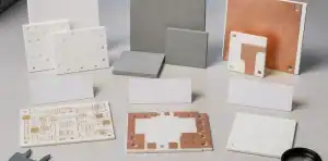 Ceramic substrate samples compare ceramic pcb vs aluminum nitride substrate terminology on an engineering bench.