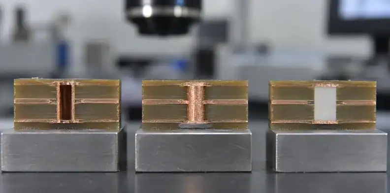 Polished via, copper-insert and ceramic sections expose the materials in the compared heat paths.